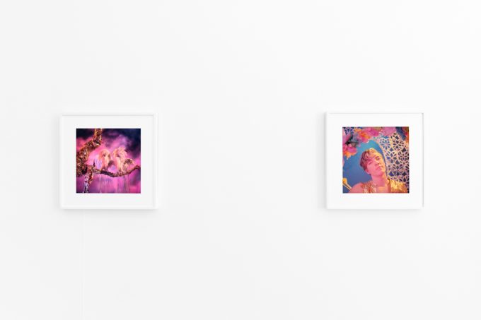 Brightly lit gallery with colorful, surreal portraits in white frames displayed along stark white walls.