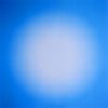 A soft-focus color photograph of a white orb against a light blue background.