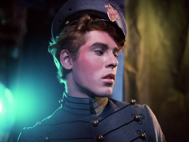 A photograph by James Bidgood of a handsome young cadet in a grey uniform