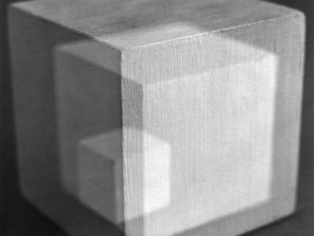 This is a black-and-white multiple-exposure photograph of painted wood cubes.