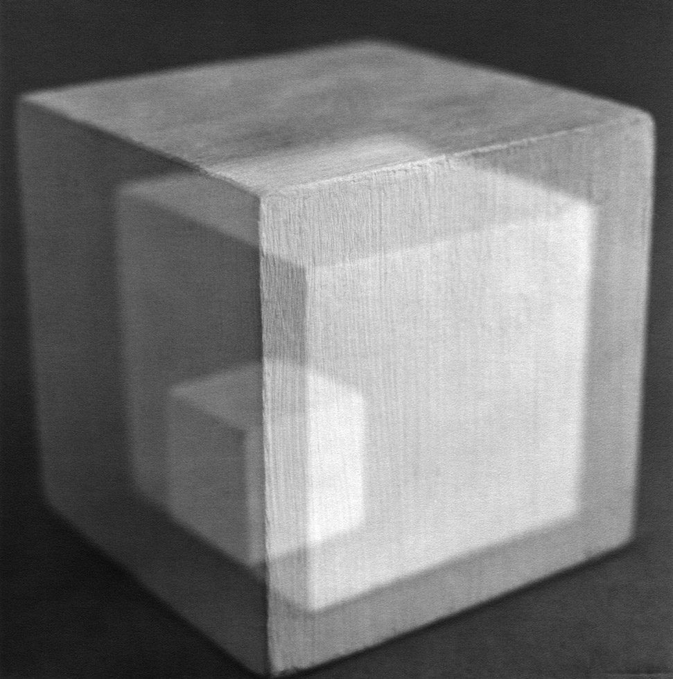 This is a black-and-white multiple-exposure photograph of painted wood cubes.