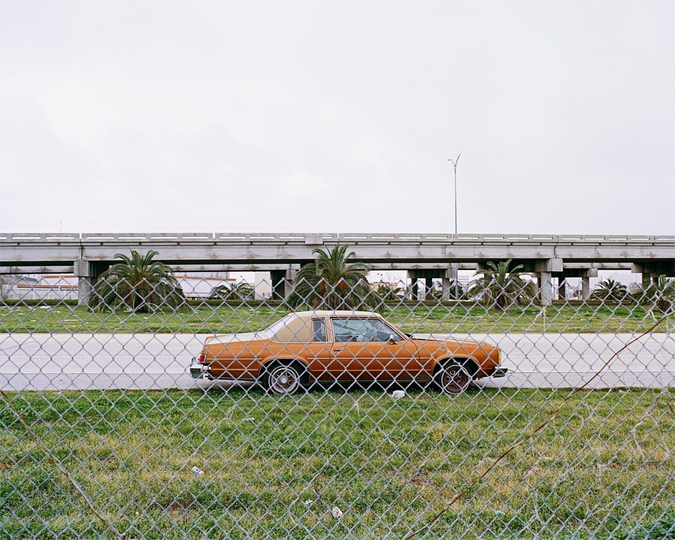 Car Through Fence, Route 10 by Amy Stein