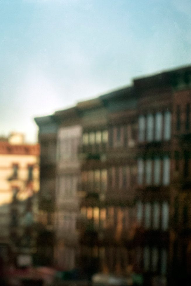 A soft focus photograph of buildings in Harlem, NYC at sunset