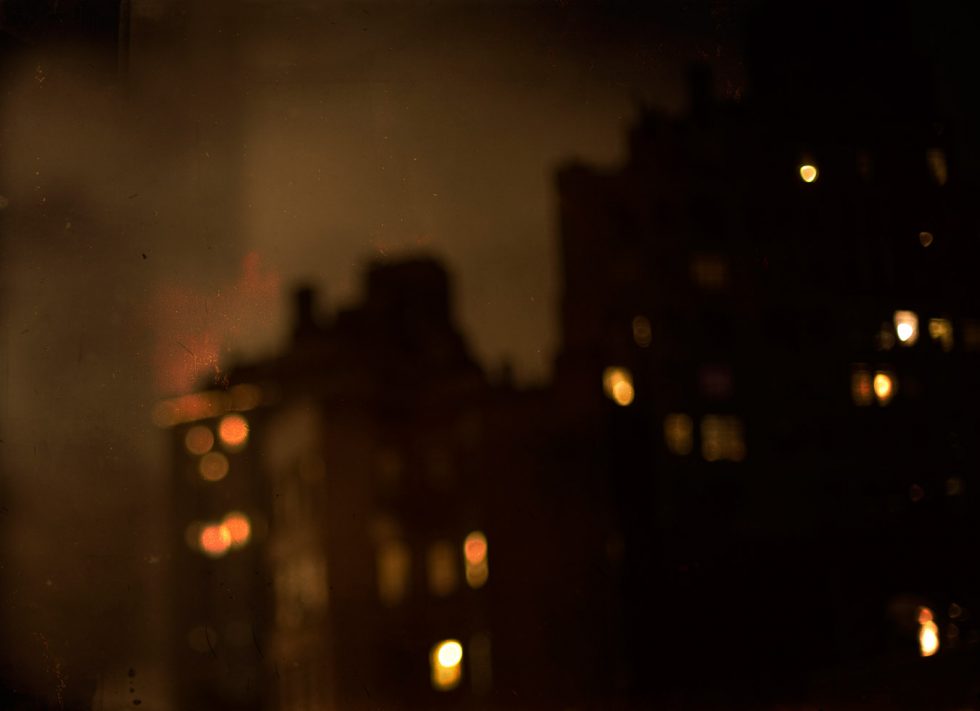 A soft focus photograph of buildings at night with some windows lit up