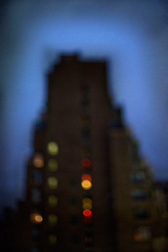 A soft focus photograph of a building with a dark blue evening sky behind it