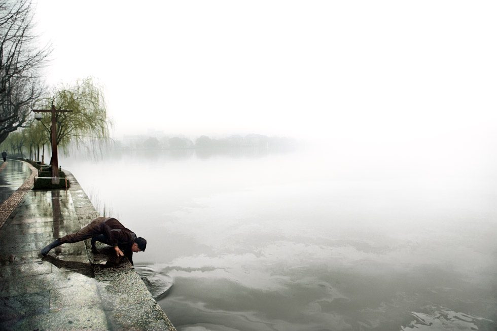 Stephen Wilkes, Man Reaching into Water by 