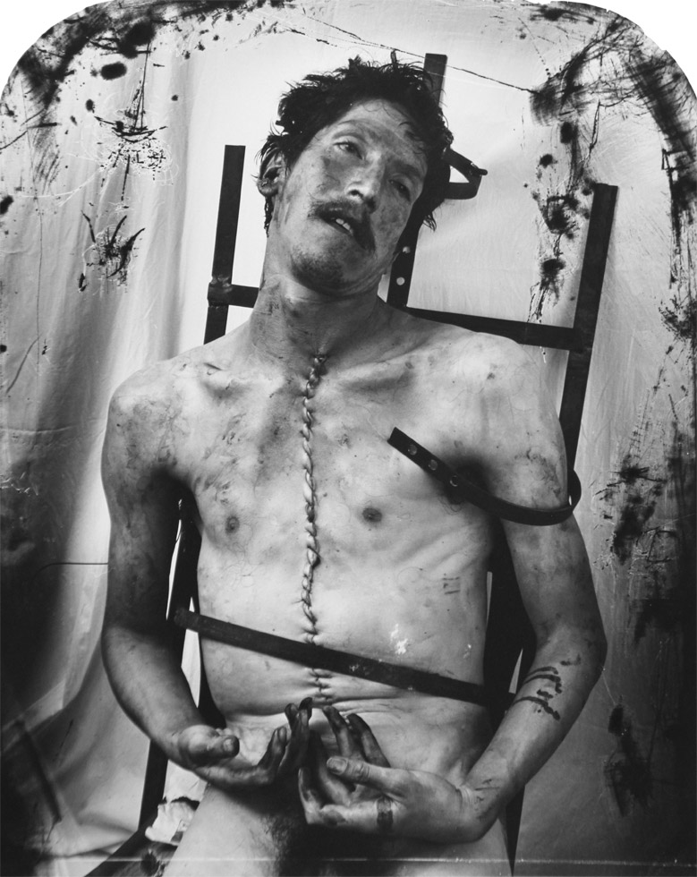 Black and white photograph by Joel-Peter Witkin titled "Glassman" picturing a nude male corpse.