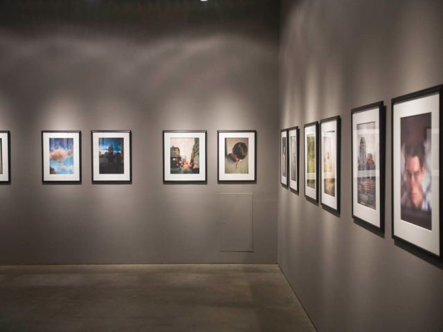 A photograph of Marc Yankus’ photographs on exhibit on display at Clamp