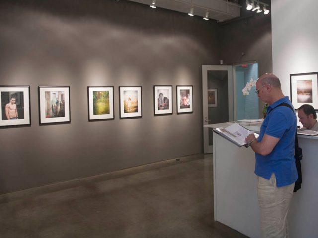 A photograph of Marc Yankus’ photographs on exhibit on display at Clamp