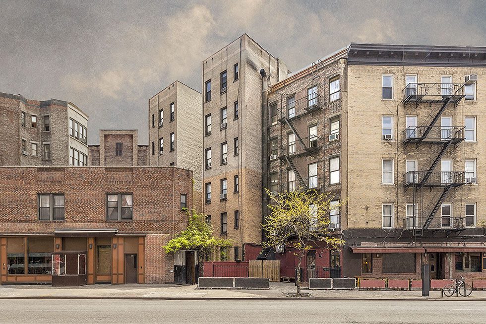 A photograph of shops and apartment buildings on a street in Greenwich Village New York City