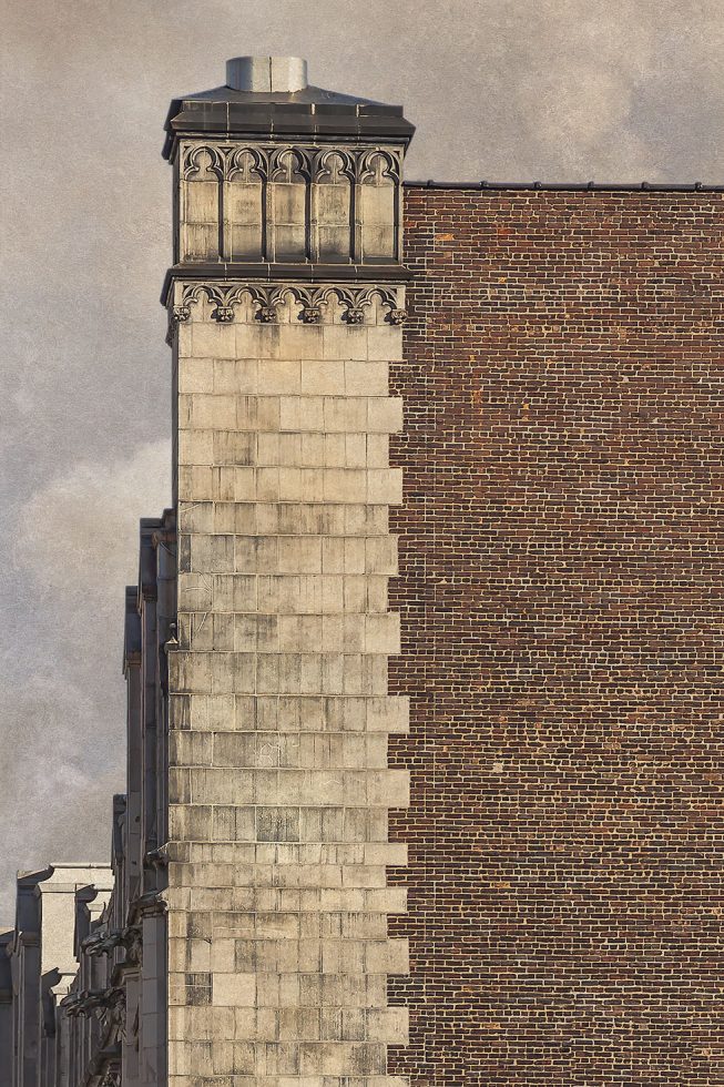 Photograph of a brick wall with a stone tower integrated into the corner