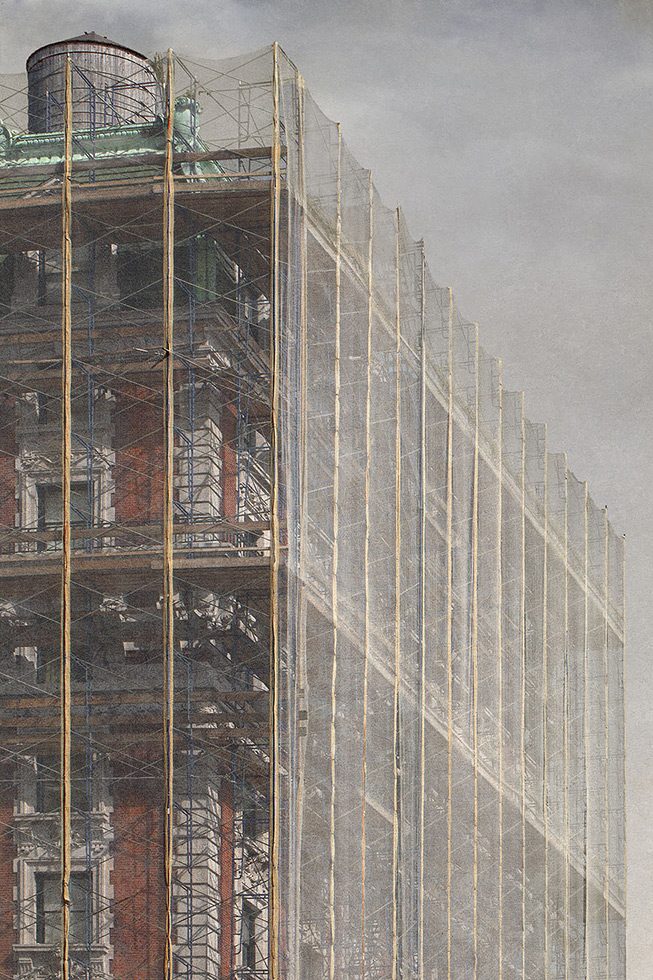 A photograph of a building in New York surrounded by scaffolding and white netting