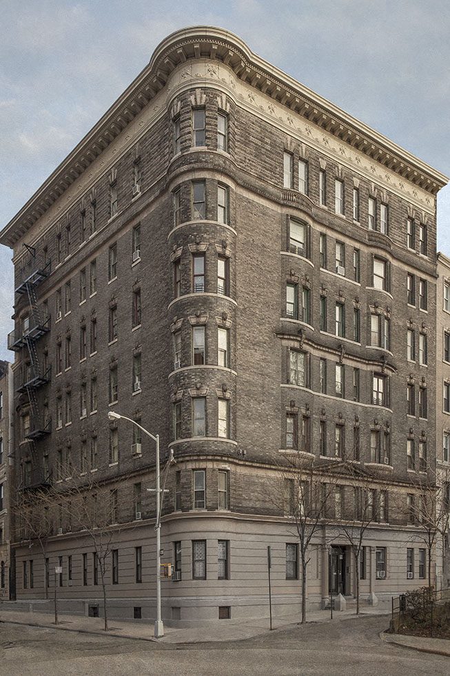 A photograph of the corner of a large brick apartment building on Riverside Drive in New York City