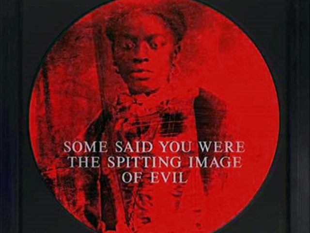 A black-and-red circular image of a Black woman with white type in capital letters across. it.
