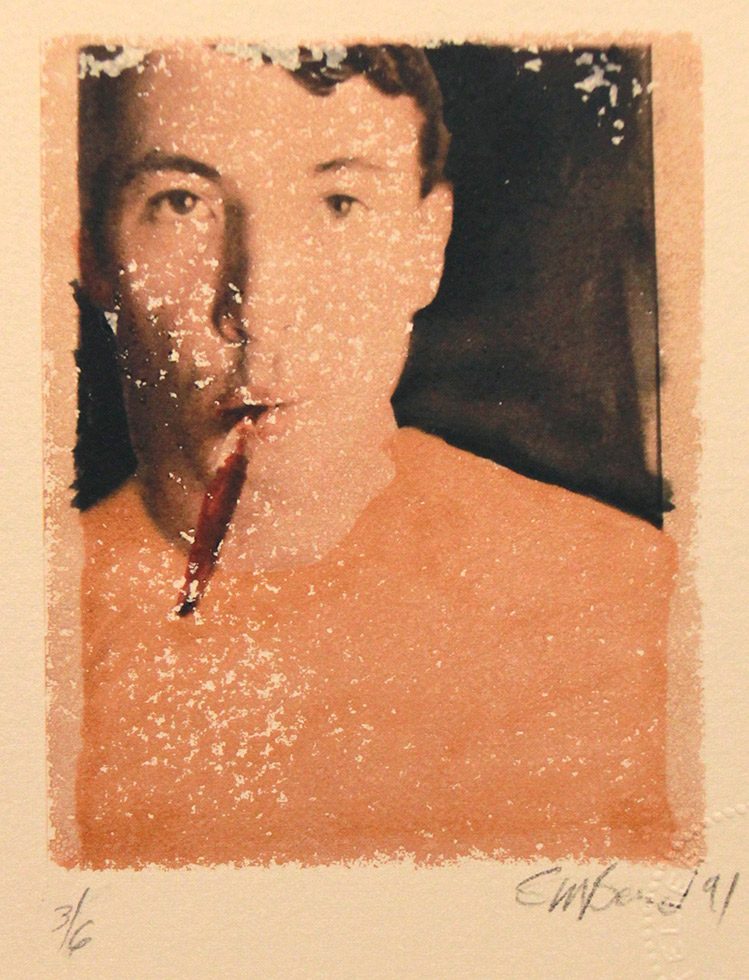 This is a color Polaroid transfer of a man in an orange t-shirt staring at the camera with a red toothbrush hanging out of his mouth.