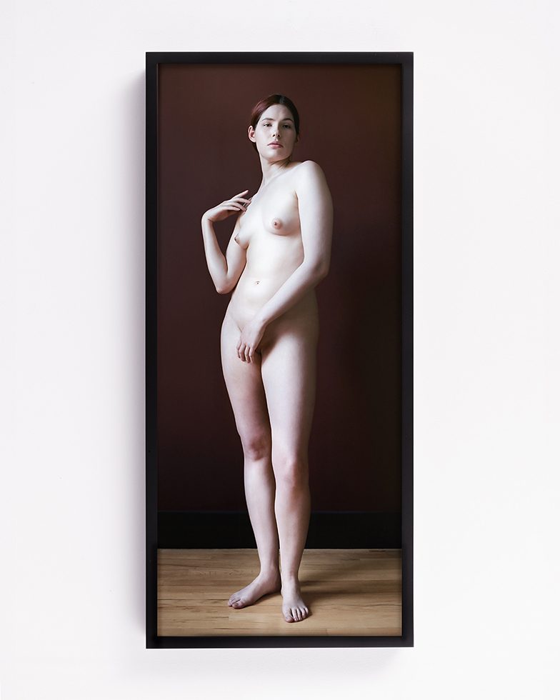 This is a full length photograph of a female nude standing.