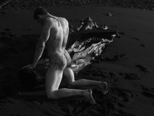 Nick Turner, Untitled (Kneeling by Driftwood)