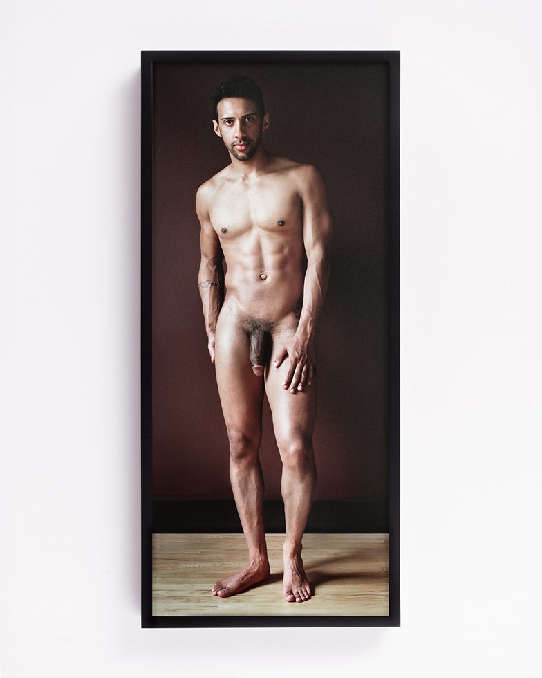 A photograph by artist Daniel Handal based on work by Lucas Cranach which shows a naked Black man named Jay with light coming from the left and a brown background.