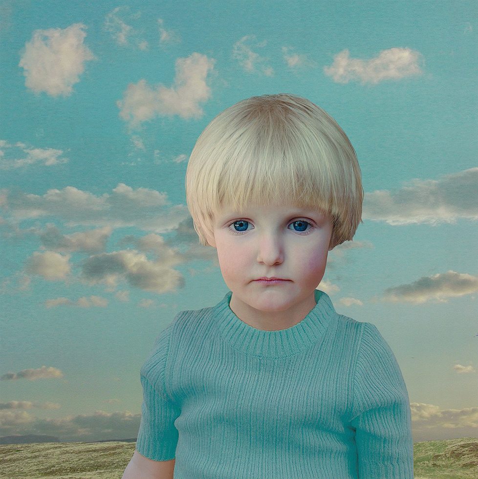 This is a digitally manipulated color photograph of a blonde child in a turquoise-colored shirt against a landscape.