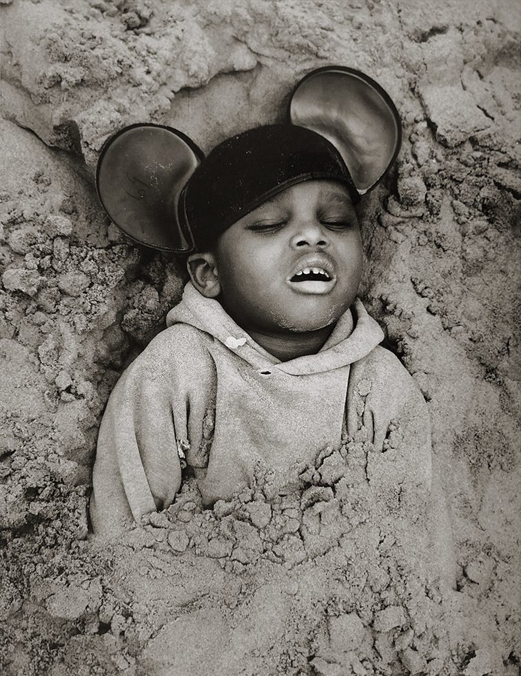 Boy in Mickey Mouse Hat, Coney Island, New York by Arthur Tress