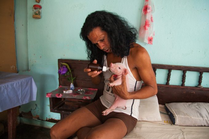 Mariette Pathy Allen, Charito at home with one-week-old piglet, Camaguey