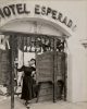 A black-and-white photograph by George Platt Lynes of Tamara Toumanova in a black dress in front of the Hotel Esperado.