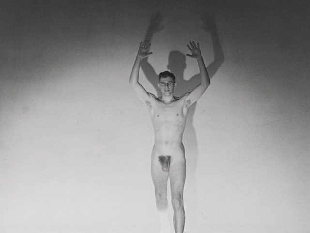 Jeremy Jackson nude with his hands in the air