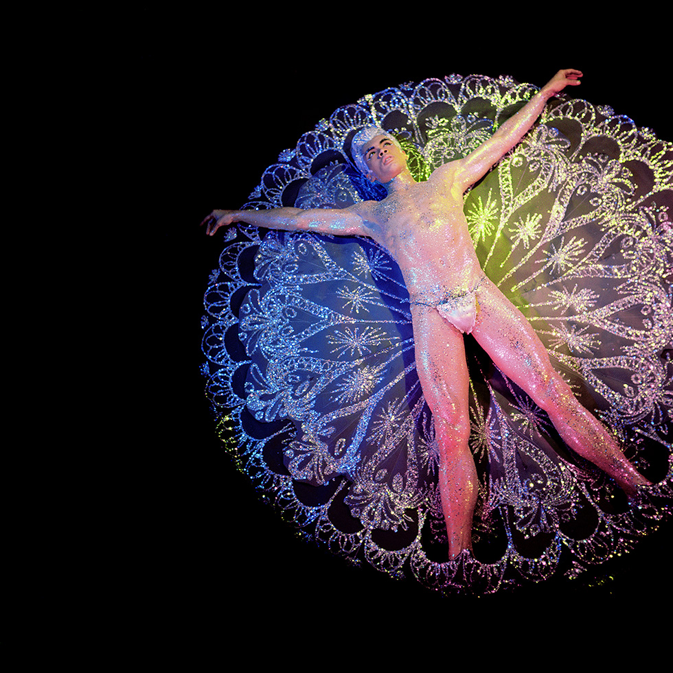 A James Bidgood photograph of Jack Frost on a snowflake against a black background