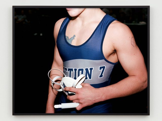 This is a close up photograph of the chest of a wrestler in his singlet.