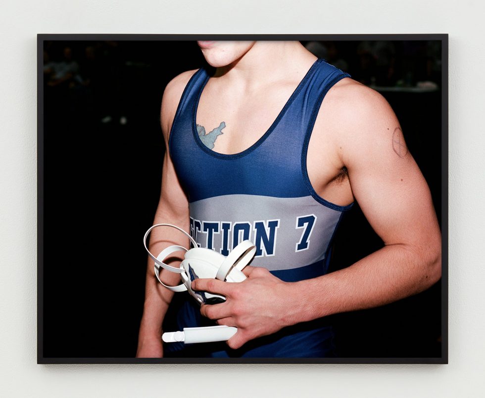 This is a close up photograph of the chest of a wrestler in his singlet.