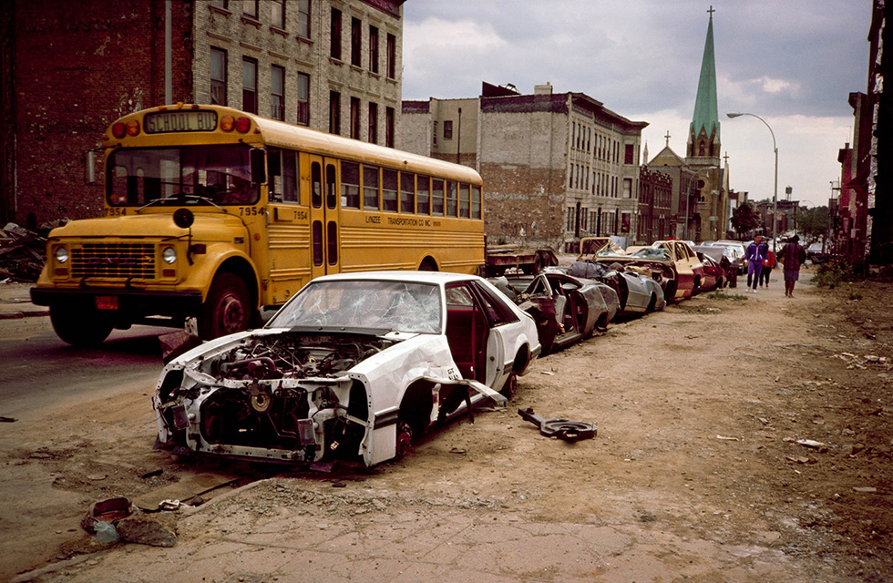 School Bus and Curbside Crushed Cars by Meryl Meisler