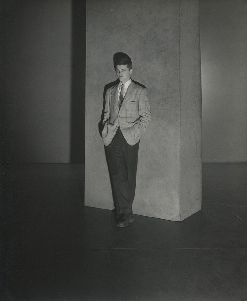 A black white photograph of Sandy Campbell wearing a jacket and tie taken by George Platt Lynes