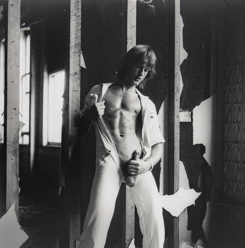 Self portrait photograph by Peter Berlin of the artist wearing a white jumpsuit