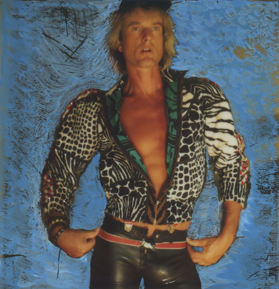 Self portrait photograph by Peter Berlin of the artist wearing a multi-patterned jacket.