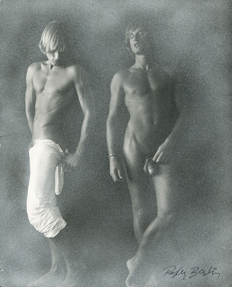 Double self portrait photograph by Peter Berlin of the artist, one of him is wearing white trousers, one of him is nude