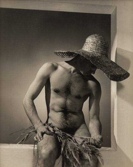 Black and white photograph of José Martinez nude wearing a large straw hat
