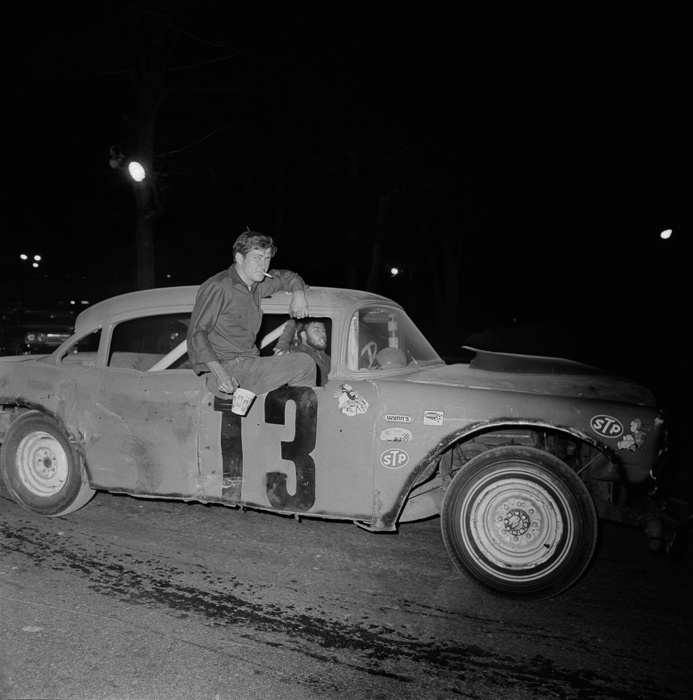 A black and white photograph taken by Henry Horenstein in 1972 at the Thomson Speedway in Thomson, Connecticut in 1972.