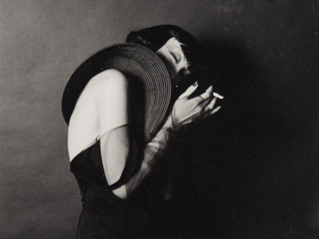 A black and white photograph by Marcus Leatherdale of a woman names Larissa holding a cigarette