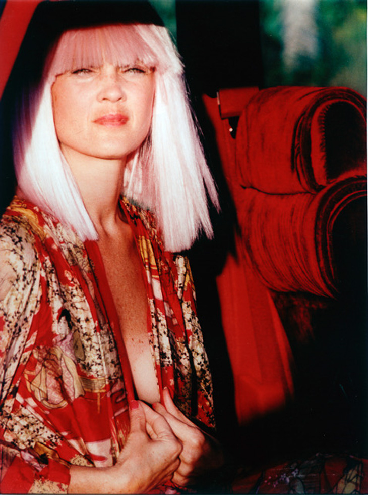 A picture of a woman wearing a pink wig and red kimono in sunlight taken by Linda Troeller at the Chelsea Hotel in 1994.