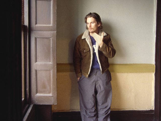 A young Ethan Hawke looks out a bright window in the Chelsea Hotel in the early 2000s, picture taken by Linda Troeller