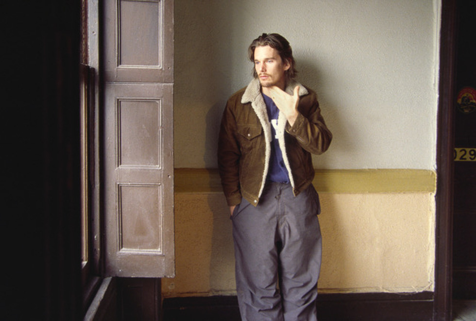 A young Ethan Hawke looks out a bright window in the Chelsea Hotel in the early 2000s, picture taken by Linda Troeller