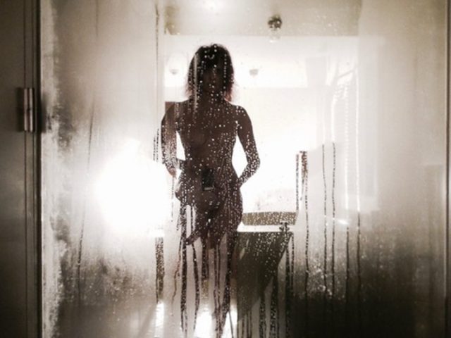 A nude self portrait of a woman named Linda Troeller in a misty mirror in the Lloyd Hotel, Amsterdam.