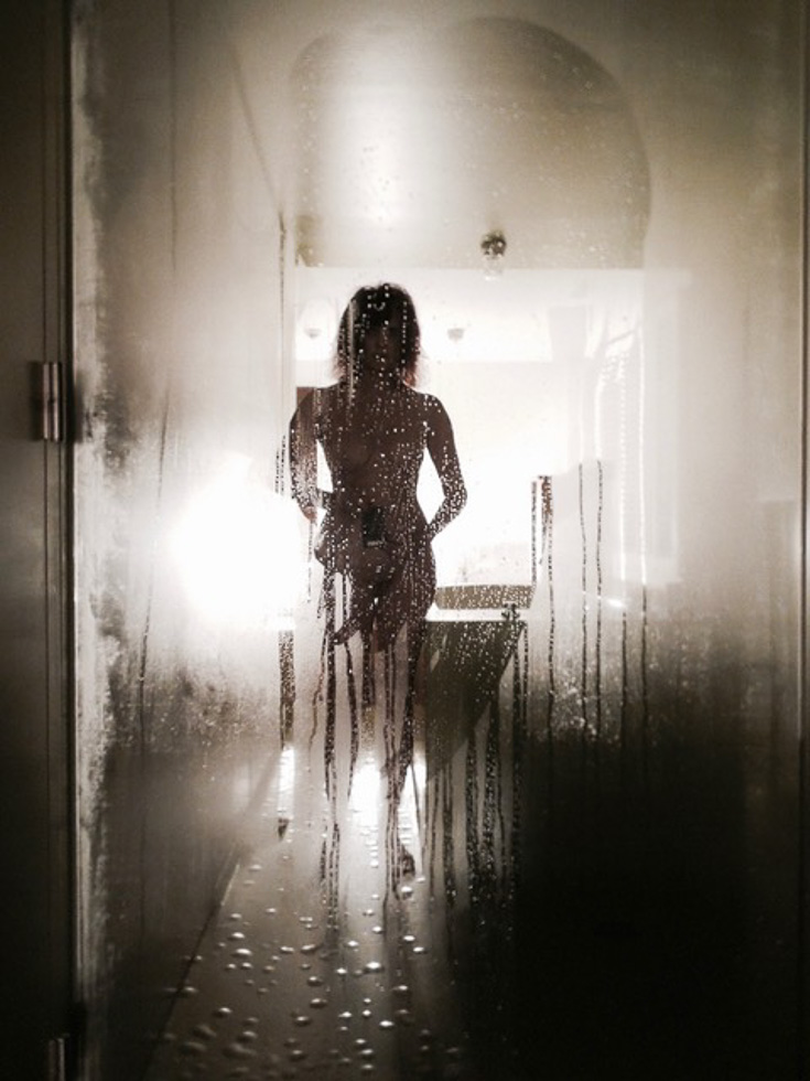 A nude self portrait of a woman named Linda Troeller in a misty mirror in the Lloyd Hotel, Amsterdam.