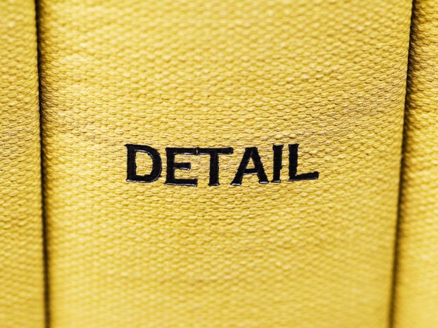 This is a photograph of a yellow book spine which says "DETAIL," taken by artist Mickey Smith.