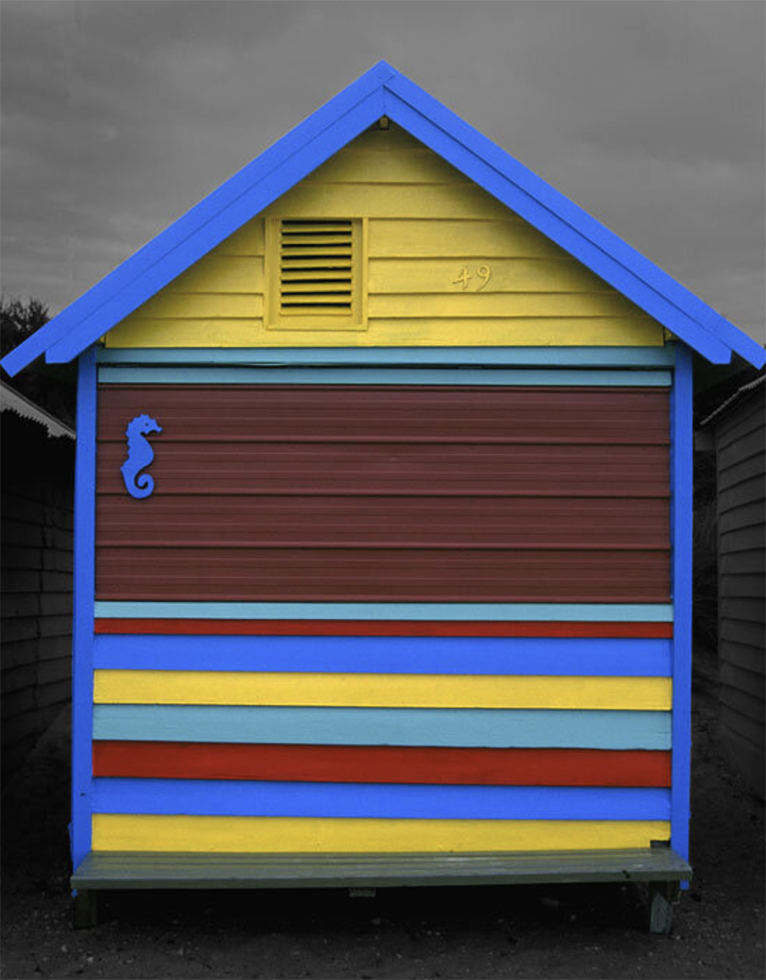 This is a photograph by Judy Gelles of an Australian Beach Box that is yellow, blue, maroon, and turquoise.