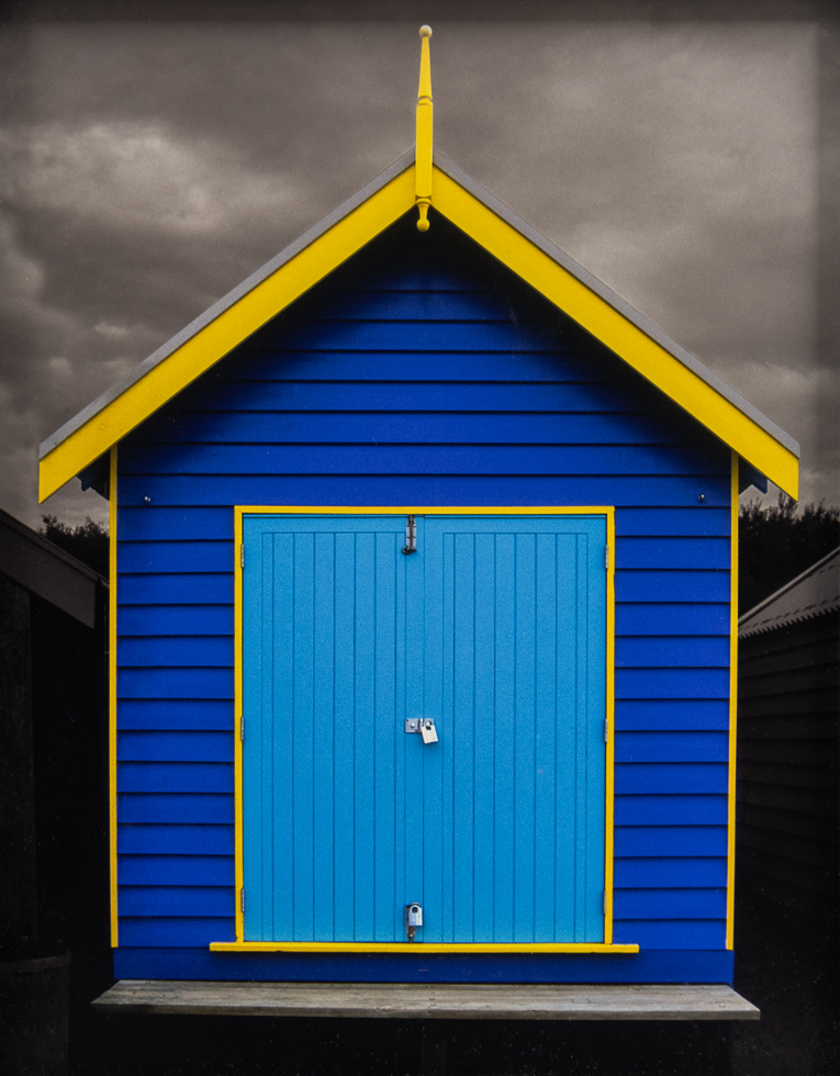 This is a photograph by Judy Gelles of an Australian Beach Box that is purple and yellow.