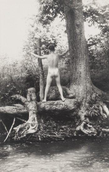 This is a black and white photo by PaJaMa of Bruce Peters Wescott nude from behind next to a body of water.
