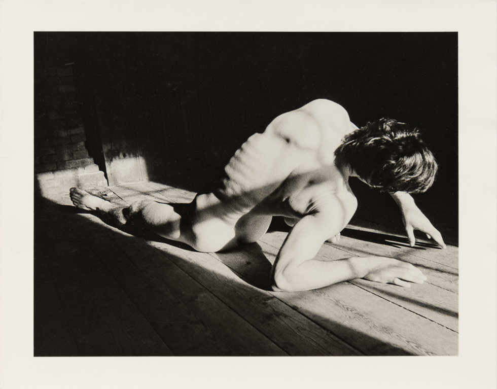 This is a vintage black and white photograph by Curtice Taylor of Alan nude in a Barn.