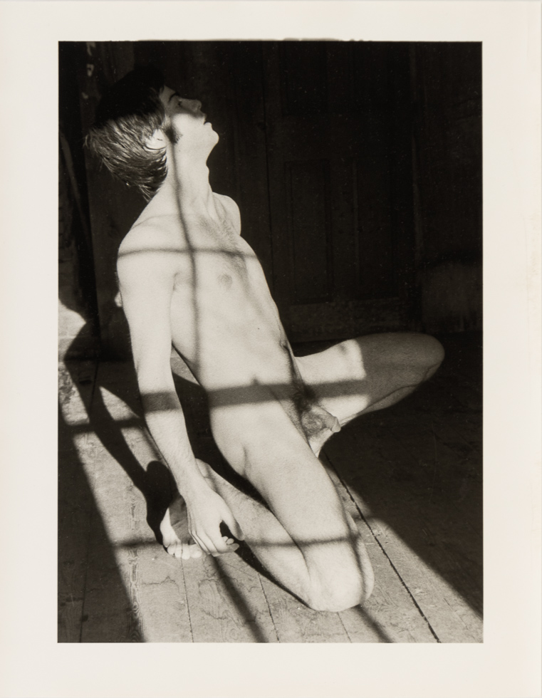 This is a vintage black and white photograph by Curtice Taylor of Alan nude in a Barn.