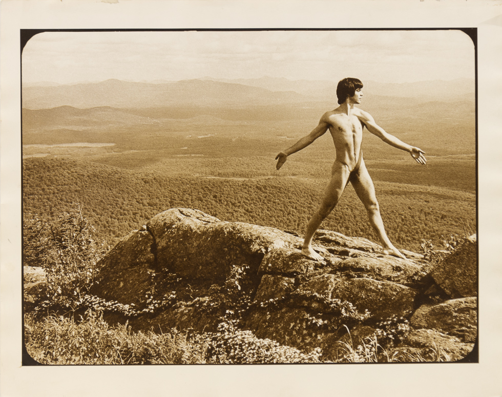 This is a sepia toned image of Alan standing naked on a cliff taken by Curtice Taylor.